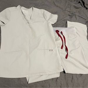 XS figs cement color scrubs. 2 pocket top and straight leg pants